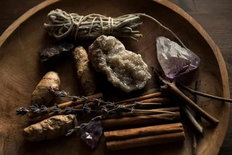 Crystals, lavender and natural objects arranged on a wooden tray